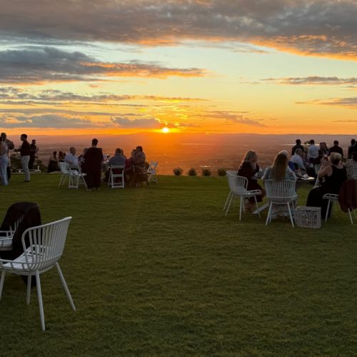 Guests enjoying a sunset ceremony overlooking panoramic views at Western Ridge Wedding Venue