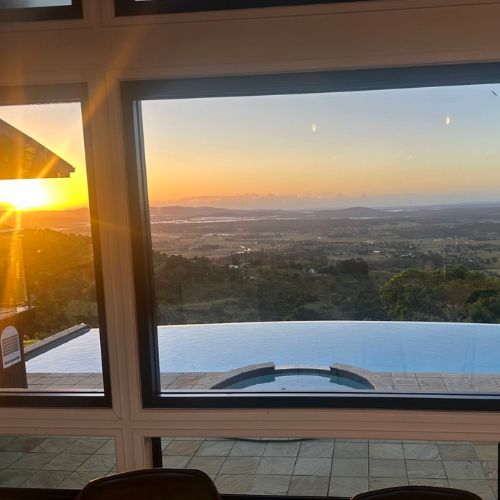 Spectacular sunrise view over the infinity pool and valleys at Western Ridge Wedding Venue