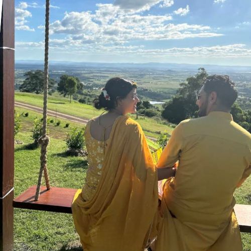 Couple dressed in yellow enjoying panoramic mountain and valley views at Western Ridge.